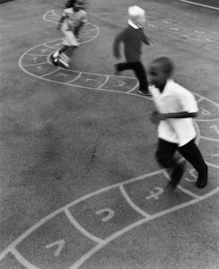 Primary School Children Chasing Each Other in a School Playground